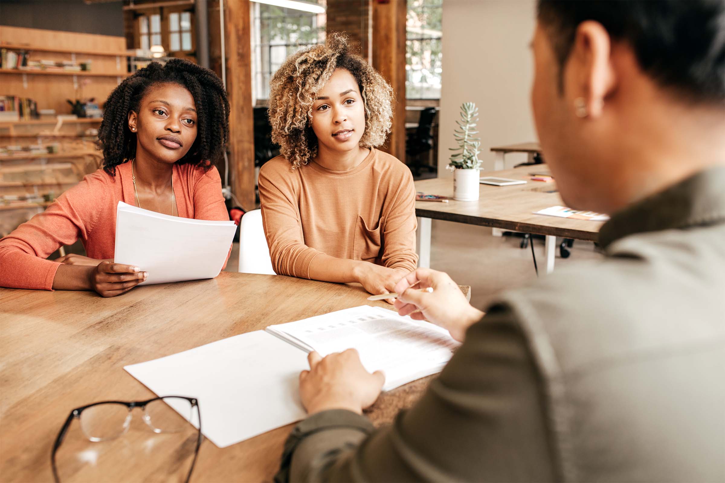black women discussing business loan figures 2