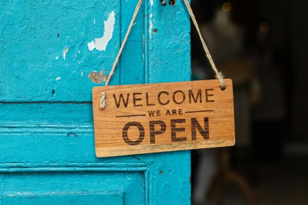 Open sign hanging off blue door