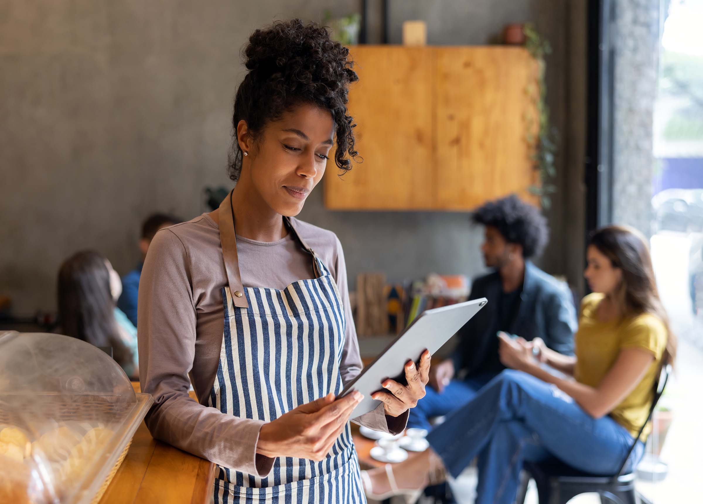 woman entrepreneur reviewing tablet meeting