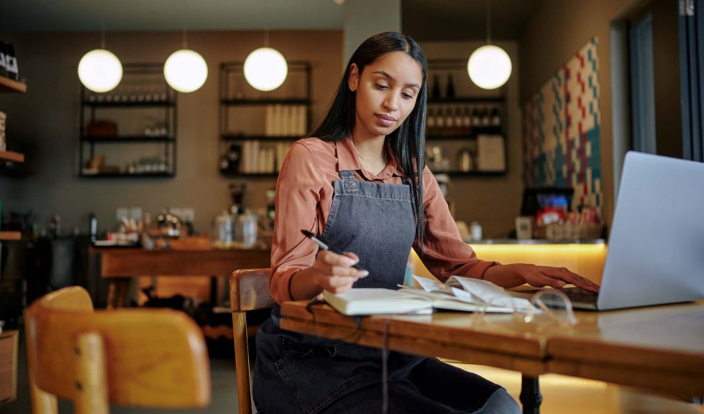 Minority Woman entrepreneur working restaurant